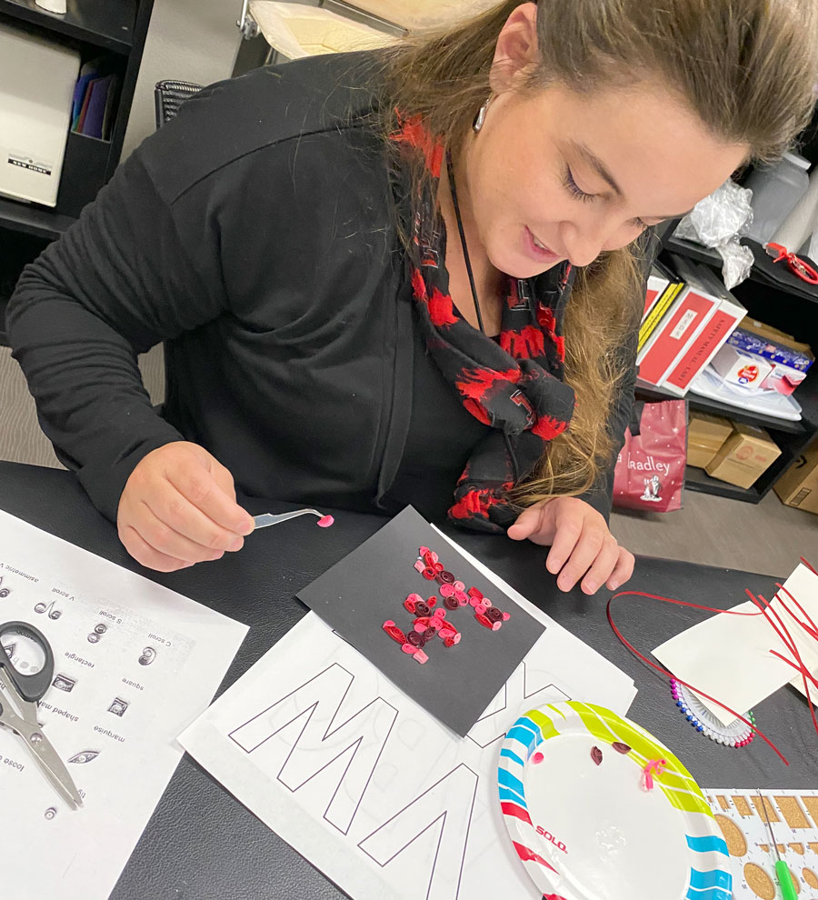 Logan Winkleman, PhD, LPC, program director in the Department of Clinical Counseling and Mental Health leads a quilling class for students to relieve stress.