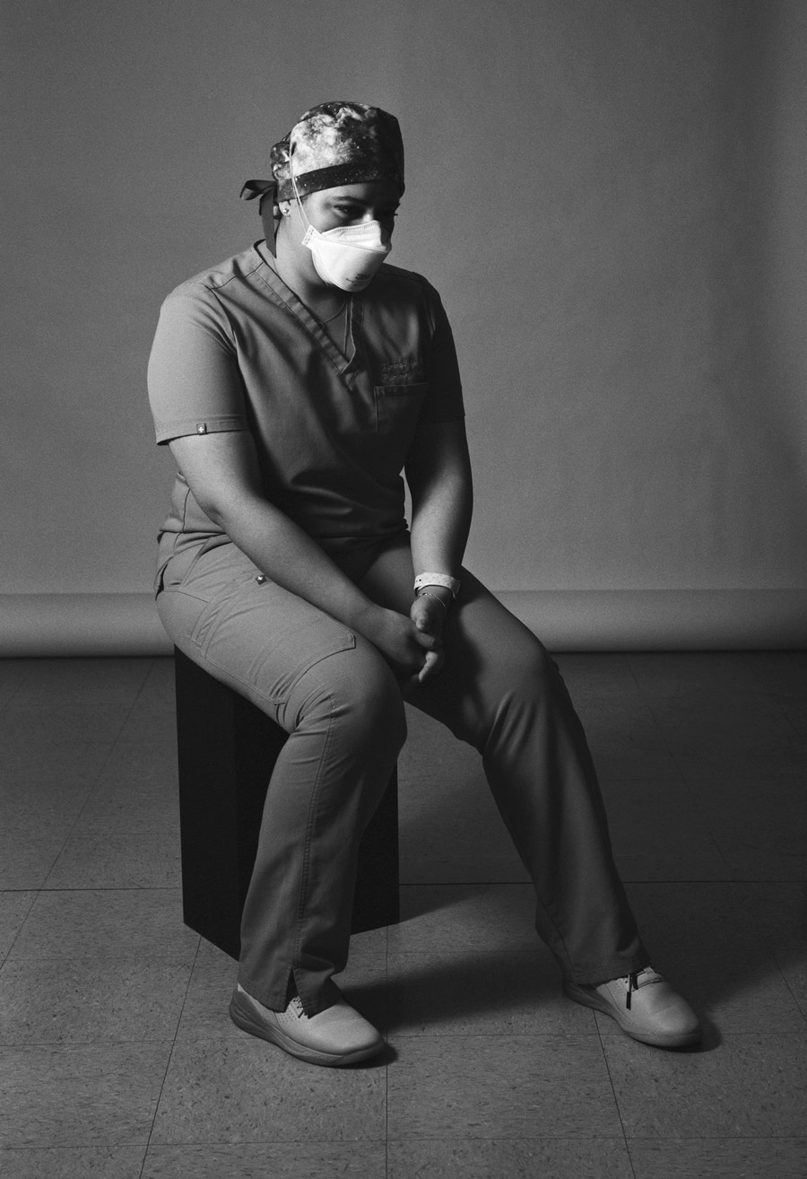 Ximena Solis wearing nurse scrubs sitting down