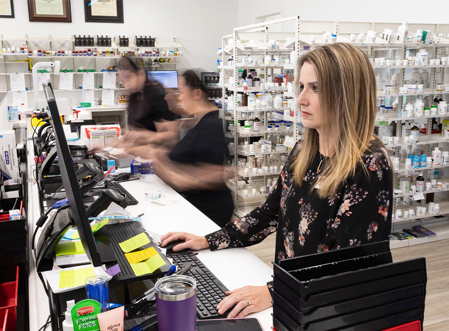 woman working the desk at a pharmacy