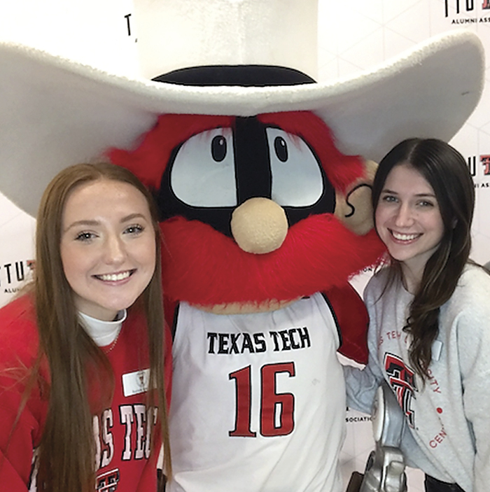 2 students posing with Red Raider mascot