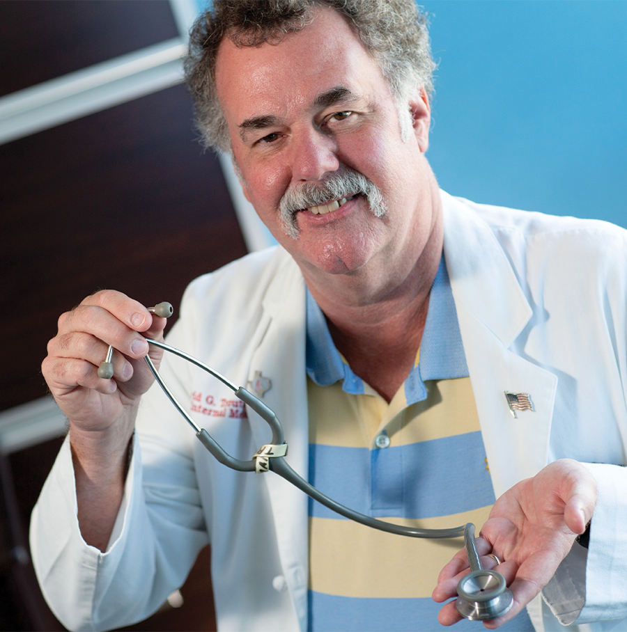 David Troutman in a doctor's coat holding up a stethoscope