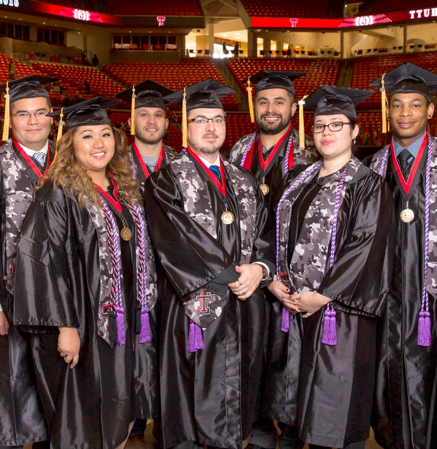 TTUHSC students in their caps and gowns at graduation in an arena