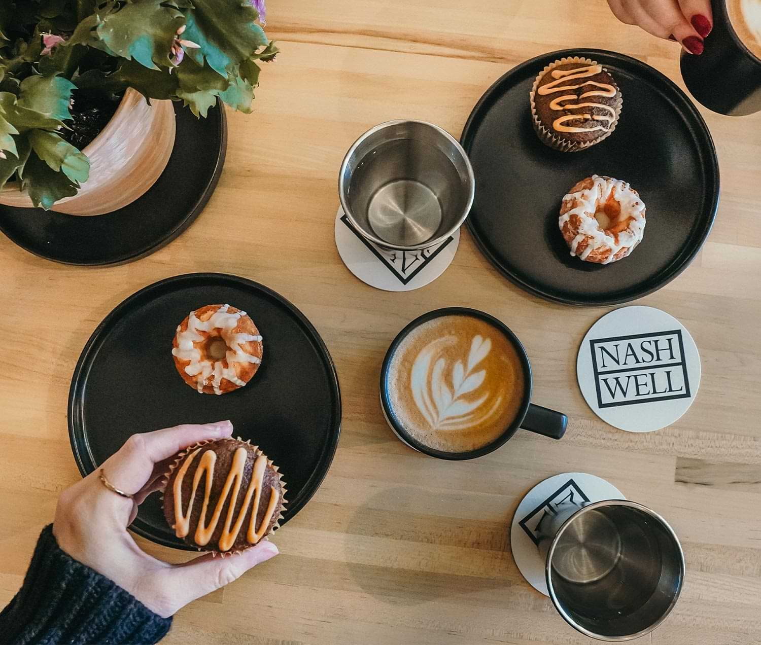 top view of a table of muffins, donuts and coffee for two