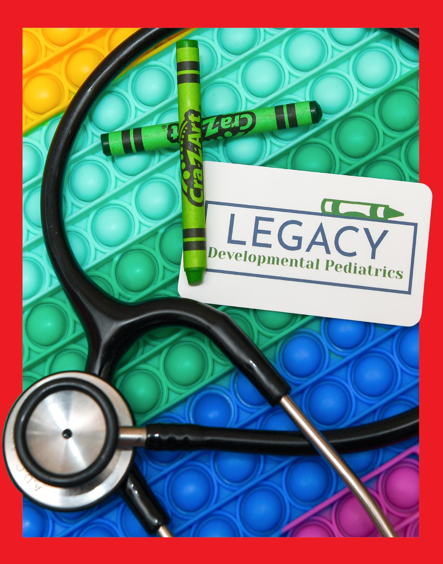crayons and stethoscope with Legacy Developmental Pediatrics card