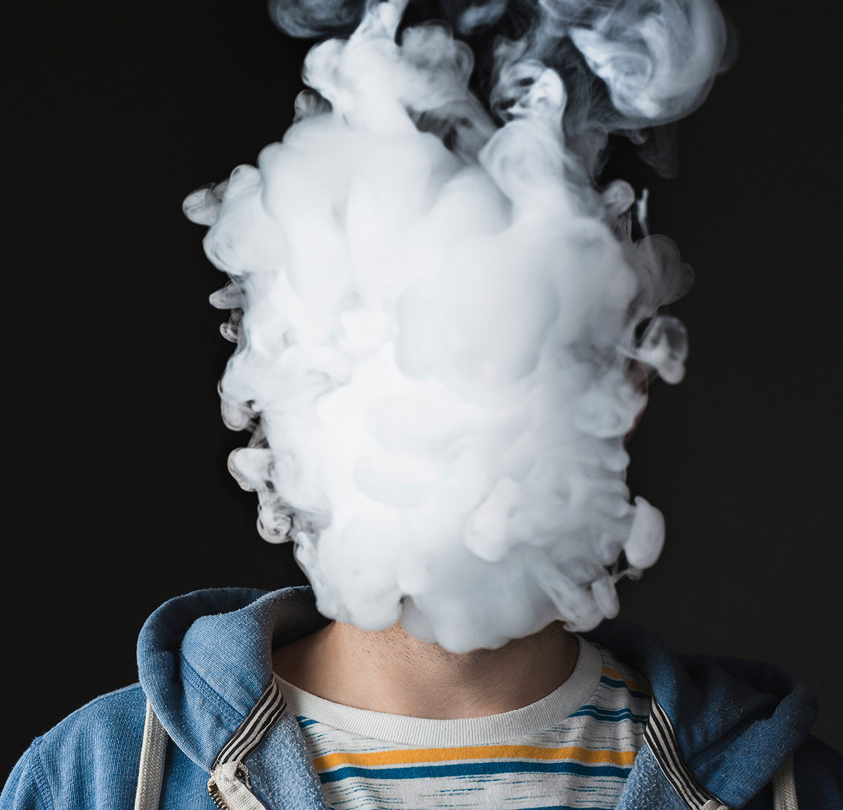 Cloud of smoke completely obscuring person's face