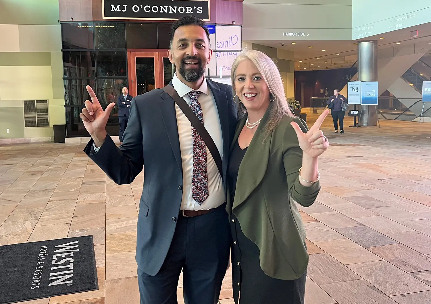 Joseph Mammarappallil, MD and Elaine Schuessler, MSN, RN stand together and smile for a photo