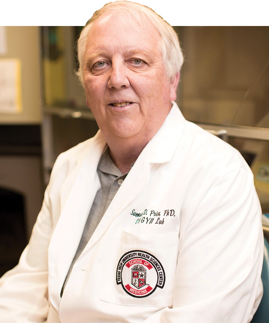Portrait of Dr. Samuel D. Prien wearing a white lab coat.